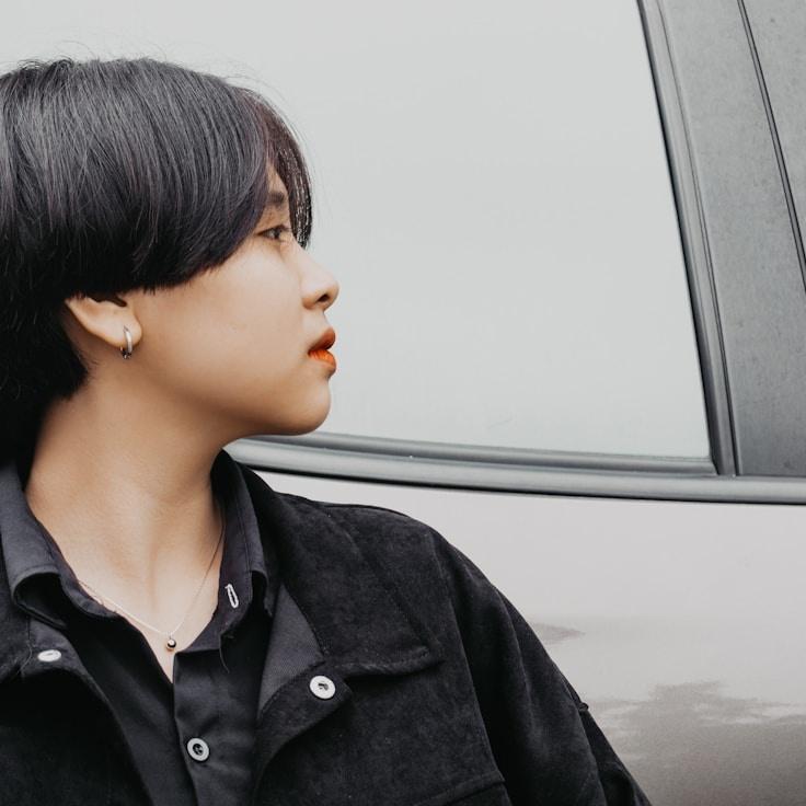 Avery Chen, Lead Design Curator at Global Process Network, reviewing corporate floral arrangements